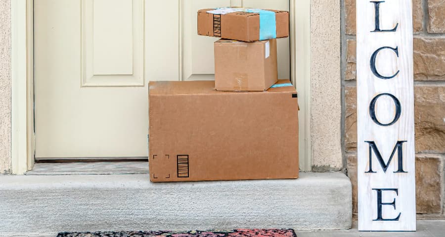 Boxes by the door of a residence with a welcome sign in Davenport